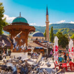 Sarajevo, Bosnia and Hercegovina – September 26, 2018: Sebilj fountain at Baščaršija with Baščaršijska Džamija in the Old Town of Sarajevo, Bosnia