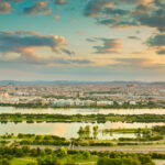 Aerial view at Vienna city and Donau river. View from danube tower right before sunset. Colorful landscape, travel destination.