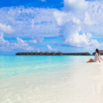 Young beautiful woman relaxing at white sand tropical beach